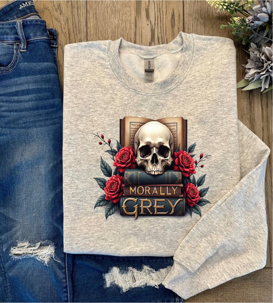 Light gray sweatshirt featuring a gothic bookish design with a skull resting on stacked books surrounded by red roses and the words "Morally Grey"