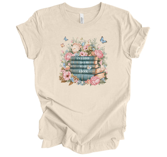 Beige t-shirt with floral and book design
